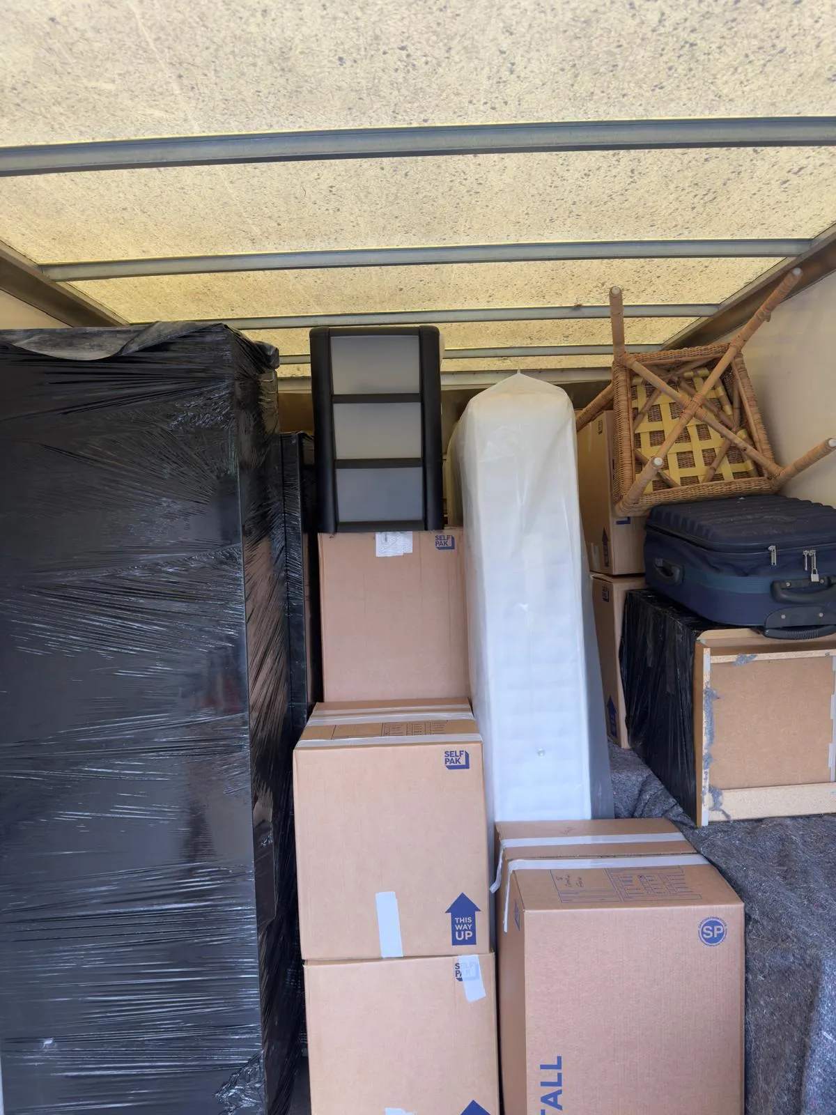 Flat removals crew loading a van in Liverpool